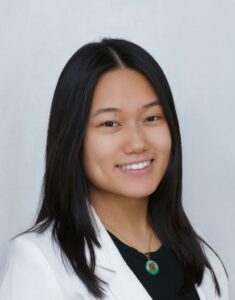 photo of Melissa Ong smiling, with straight hair and white coat